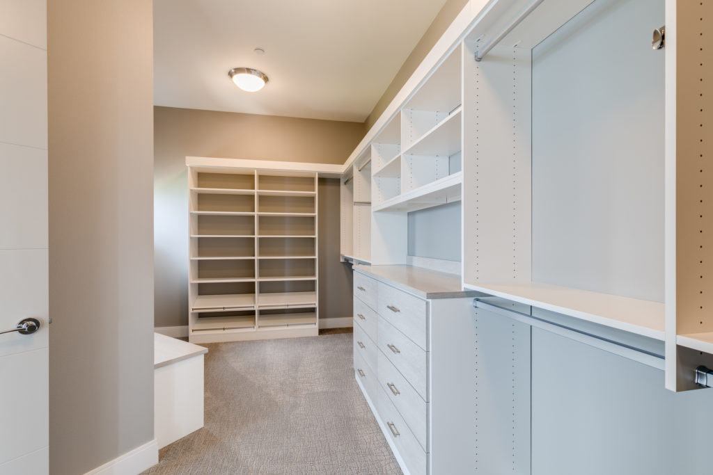 Luxury large master walk-in closet with lots of storage and drawers